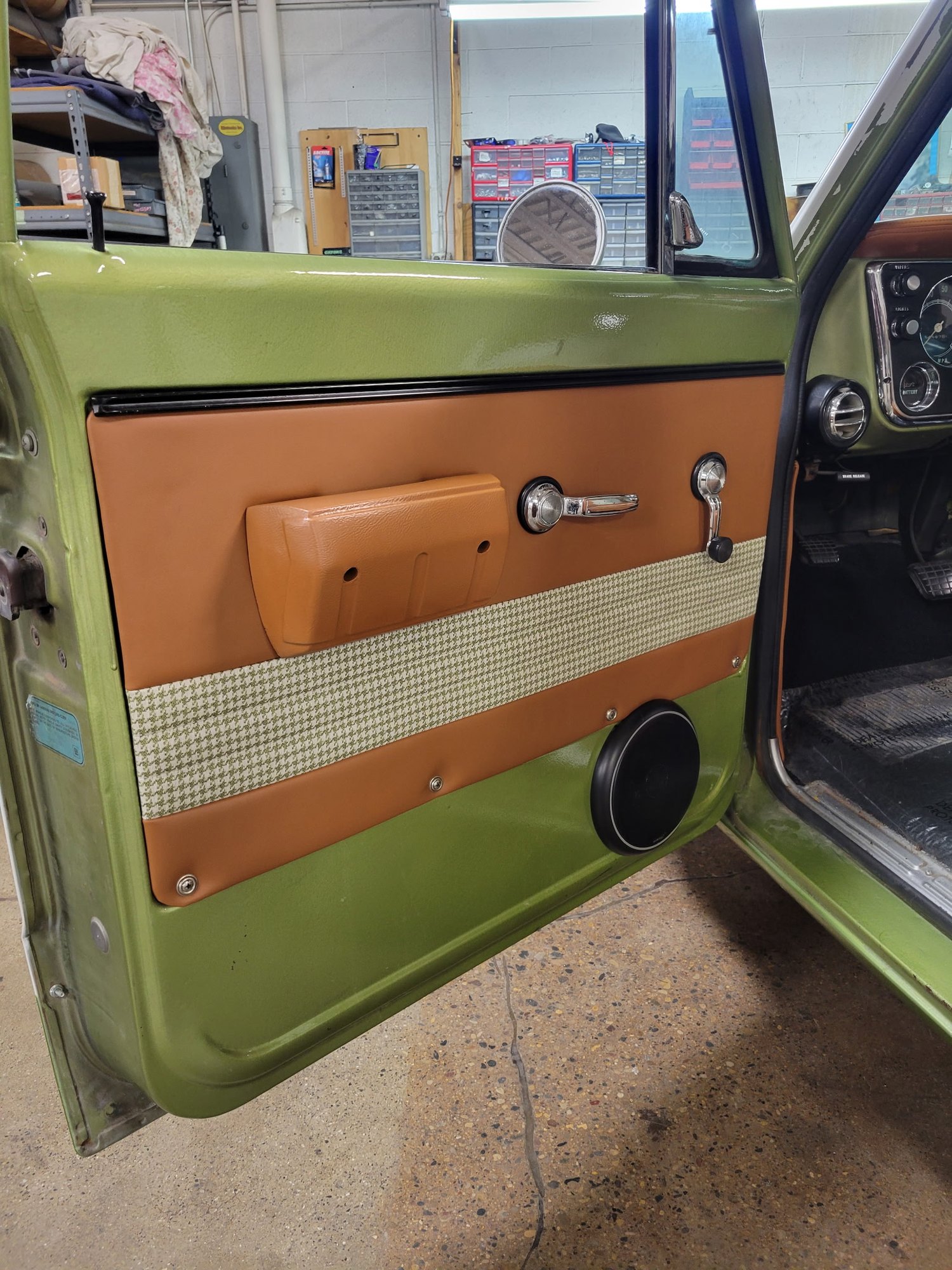 Custom tan and houndstooth door panel with integrated speaker