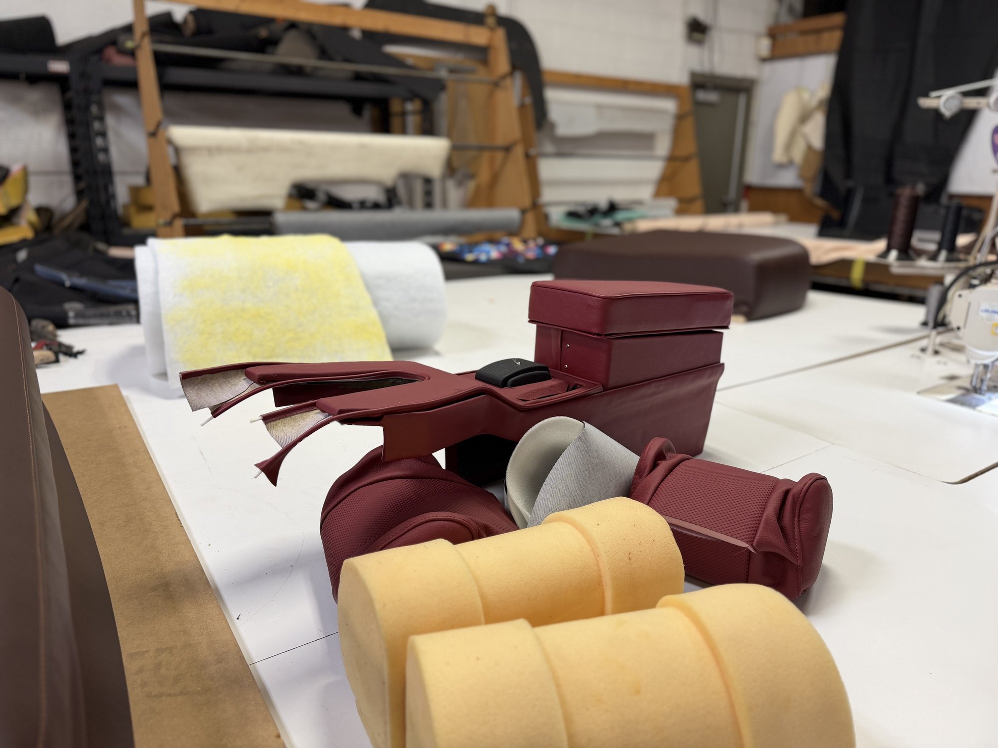 Custom red upholstery and foam being crafted inside the workshop