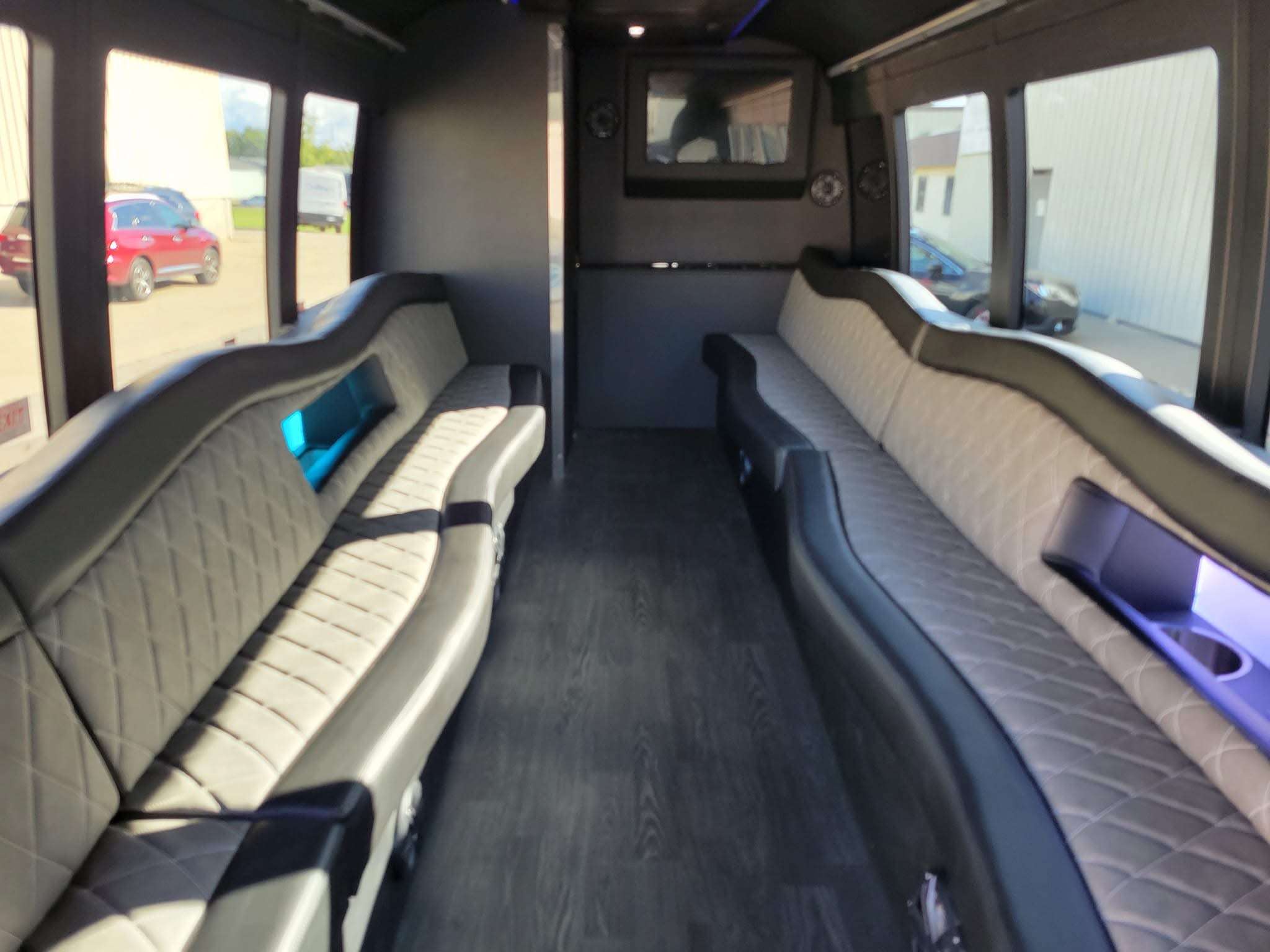 Completed specialty coach interior with custom seating, flooring, and built-in lighting