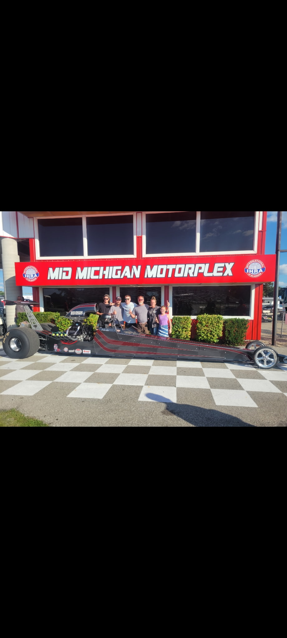 Jim Thurston with family and friends beside his dragster at Mid Michigan Motorplex